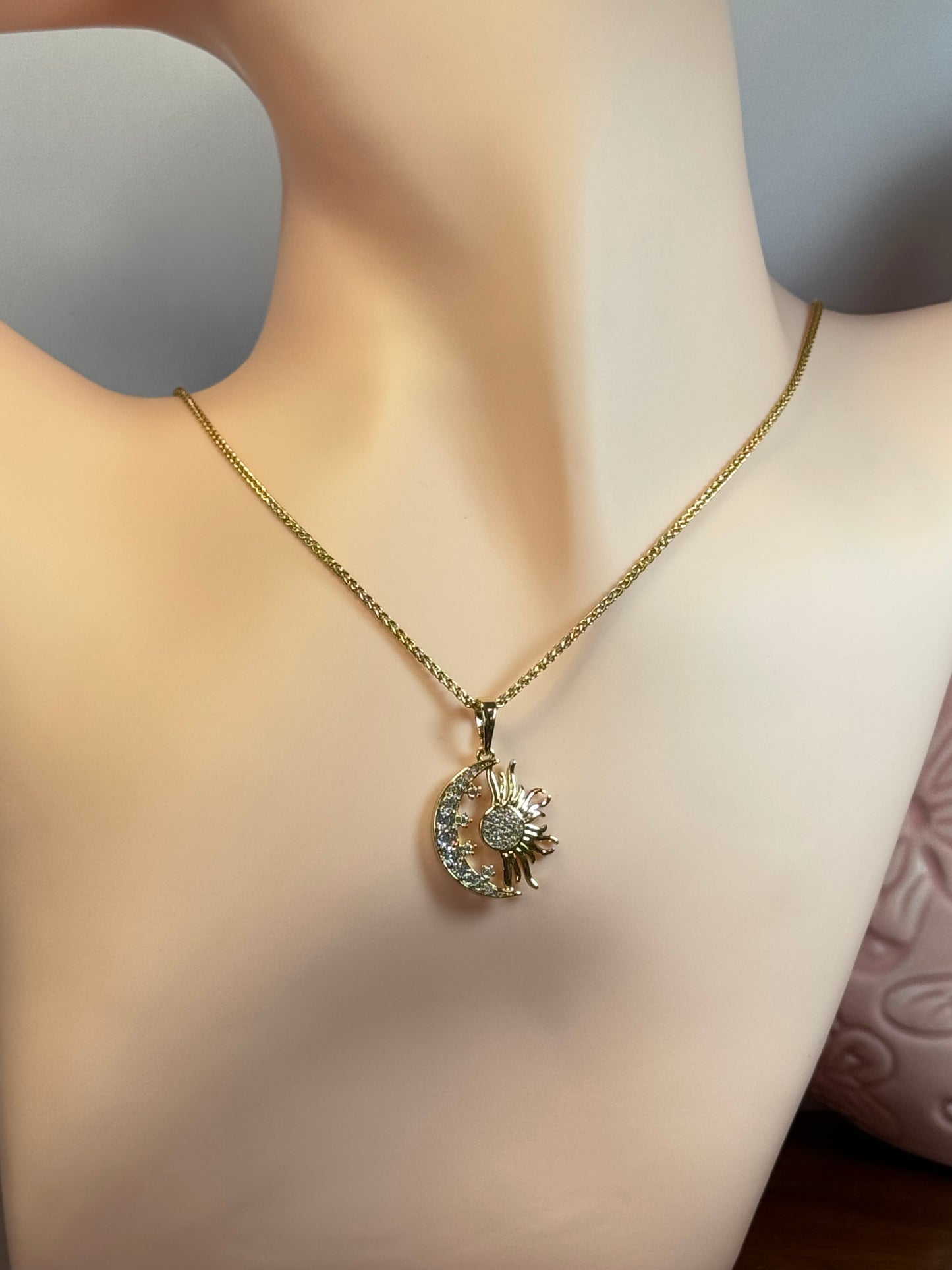 Necklace with moon and sun charm